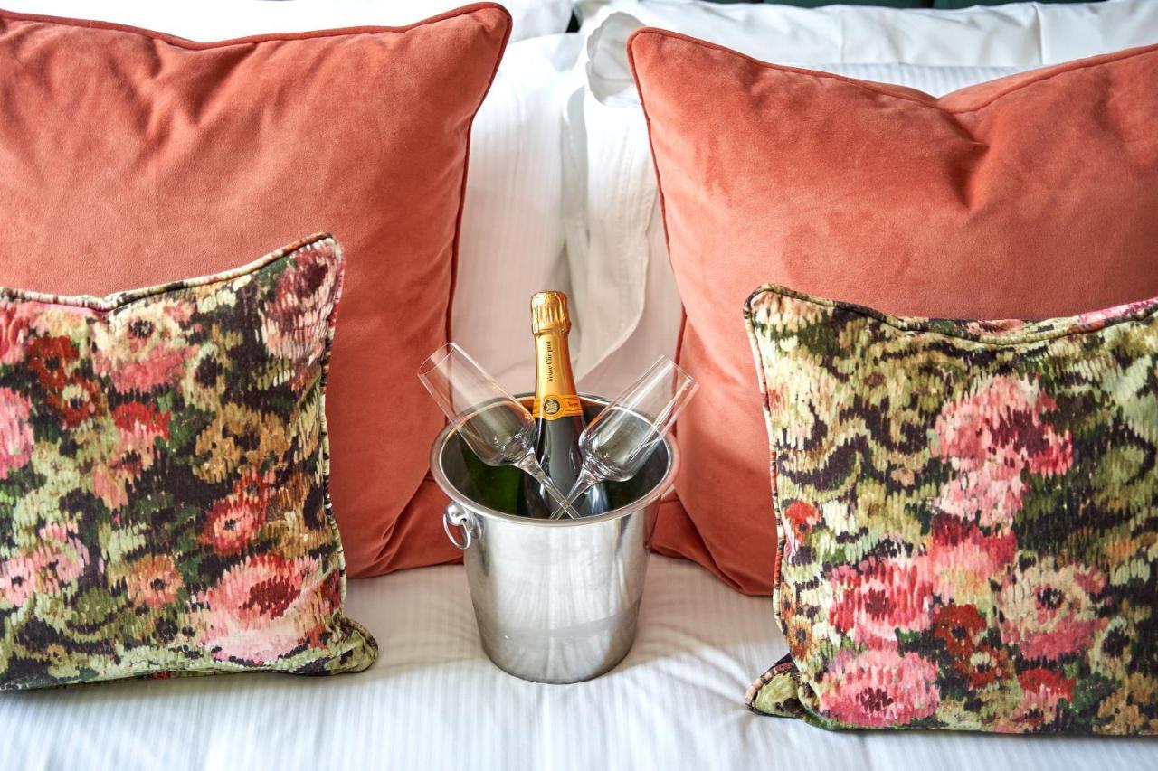 The Methuen Arms Hotel Corsham Exterior photo A champagne bottle in a champagne bucket
